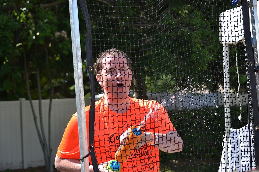 St. Martha music teacher Samuel Francis fights back from the dunk tank.