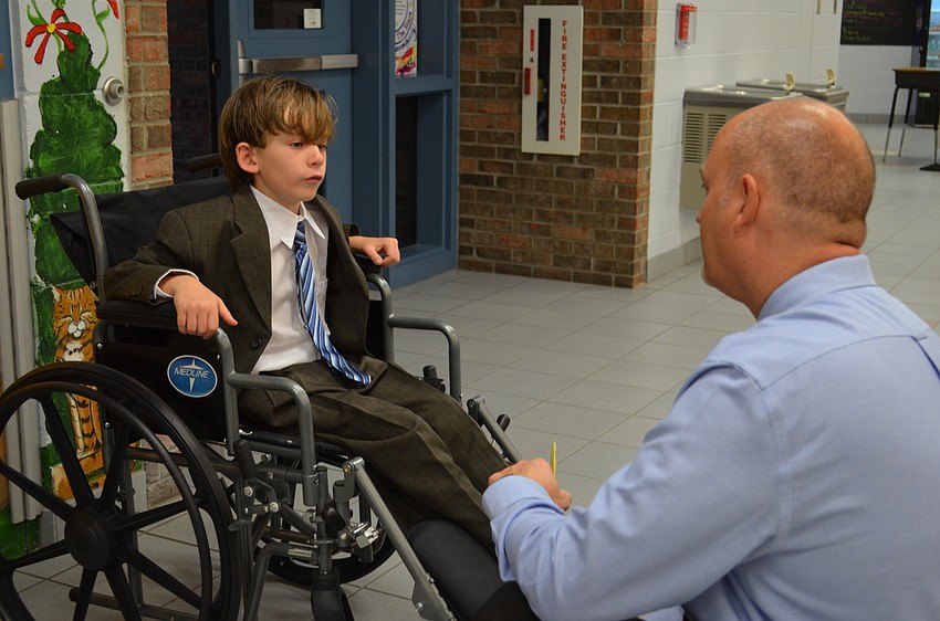 Ashton Elementary School Principal, Christopher Renouf listens to Connor Smith as Franklin D. Roosevelt.