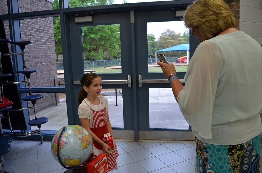 Whitney Tucker records Olivia Vafeas give her presentation on Clara Barton.