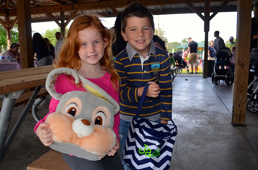 Addison Marfia — Scott and Jackson Brock show off their candy-collecting baskets, while their fathers chat.