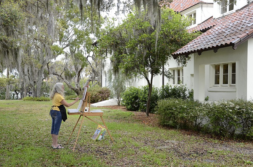 Judy Klein, a Sarasota resident and four-year member of the Light Chasers, stands near the Mansion for her painting.