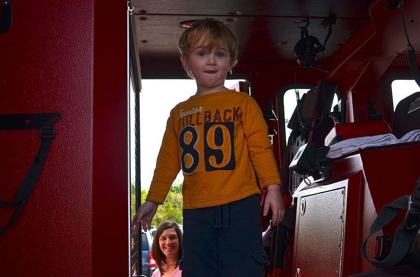 Owen Tyler, 3, inspects a local fire truck.