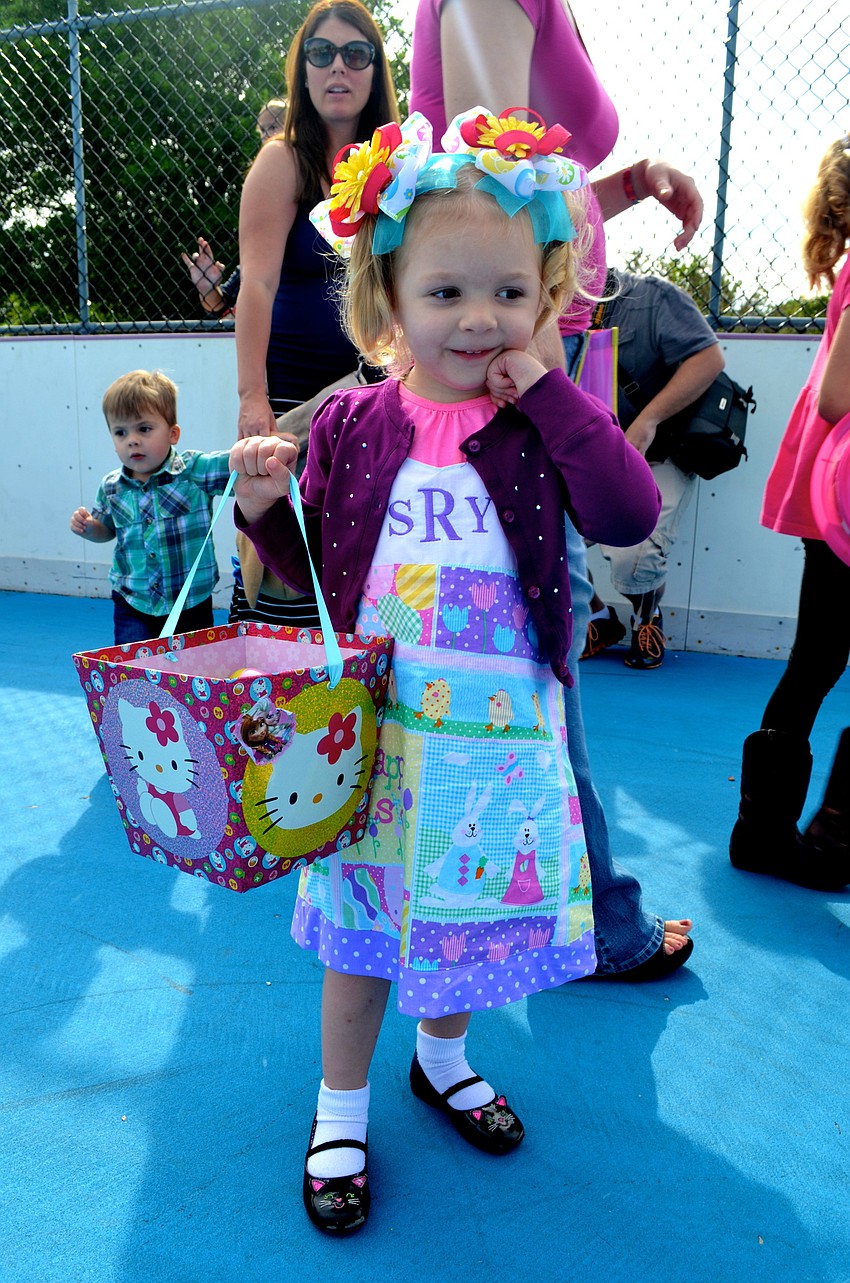 Romana Youngblood sports a handmade Easter dress, while showing off a basket full of eggs.
