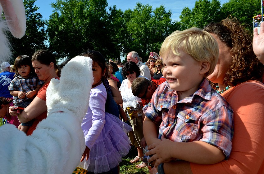 Jaxon Baker gives the Easter Bunny a high five.