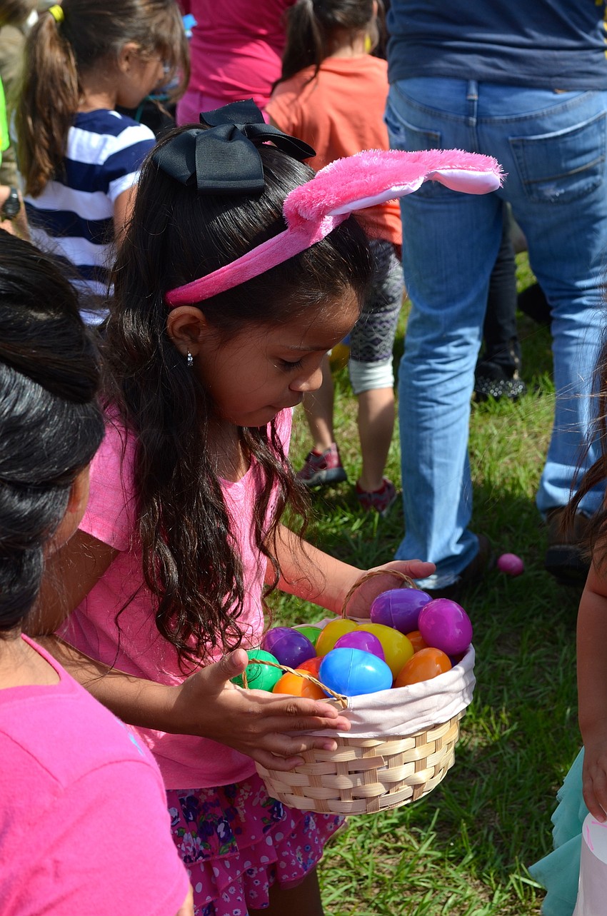 Alessandra Becerra admires her growing mound of Easter eggs.