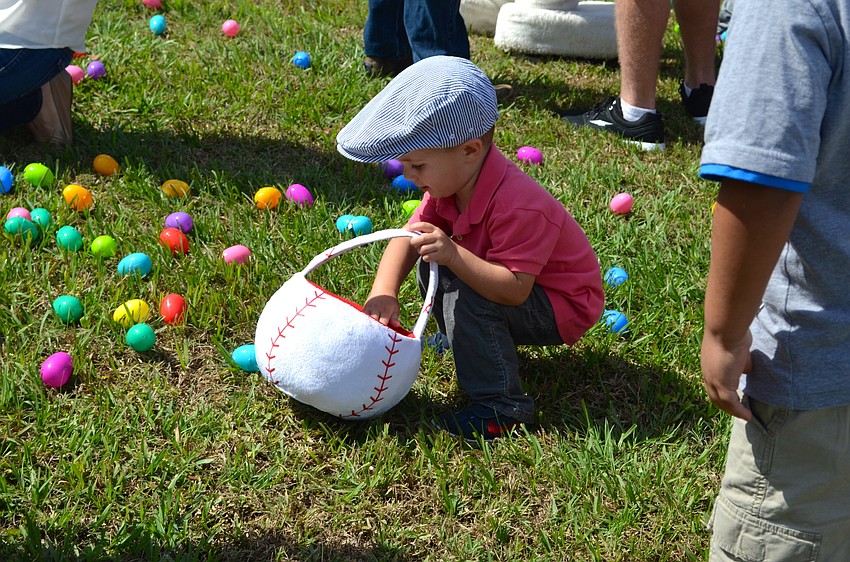 Two-year-old Bourne Broadway finds an Easter egg gold mine in a corner of the field.