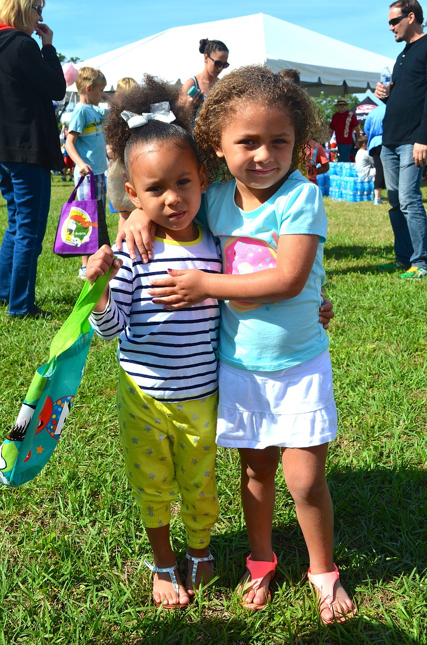 Jada Hicks and Aubrey Mitchell decide whether to snack on cotton candy or go on the giant slide.