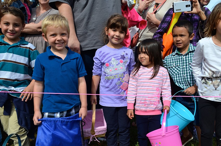 Austin Sheppard, Sariah Belgacem and Lamia Hallak are all smiles as they see acres covered in thousands of Easter eggs.