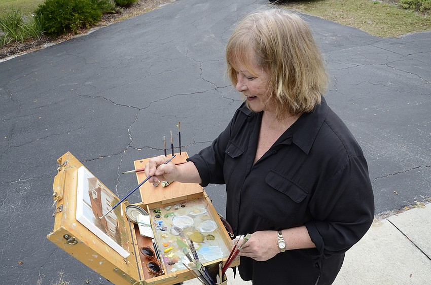 Sharon Yarbrough, a Port Charlotte resident, paints the Edson Mansion.