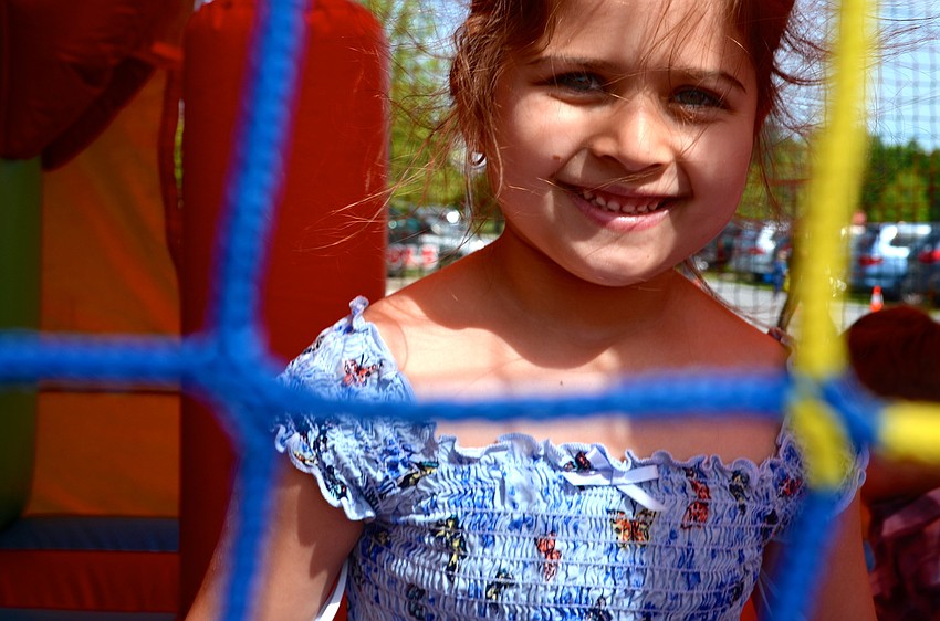 Five-year-old Jaiden Marie Wagner enjoys jumping I the bounce house with her friends.