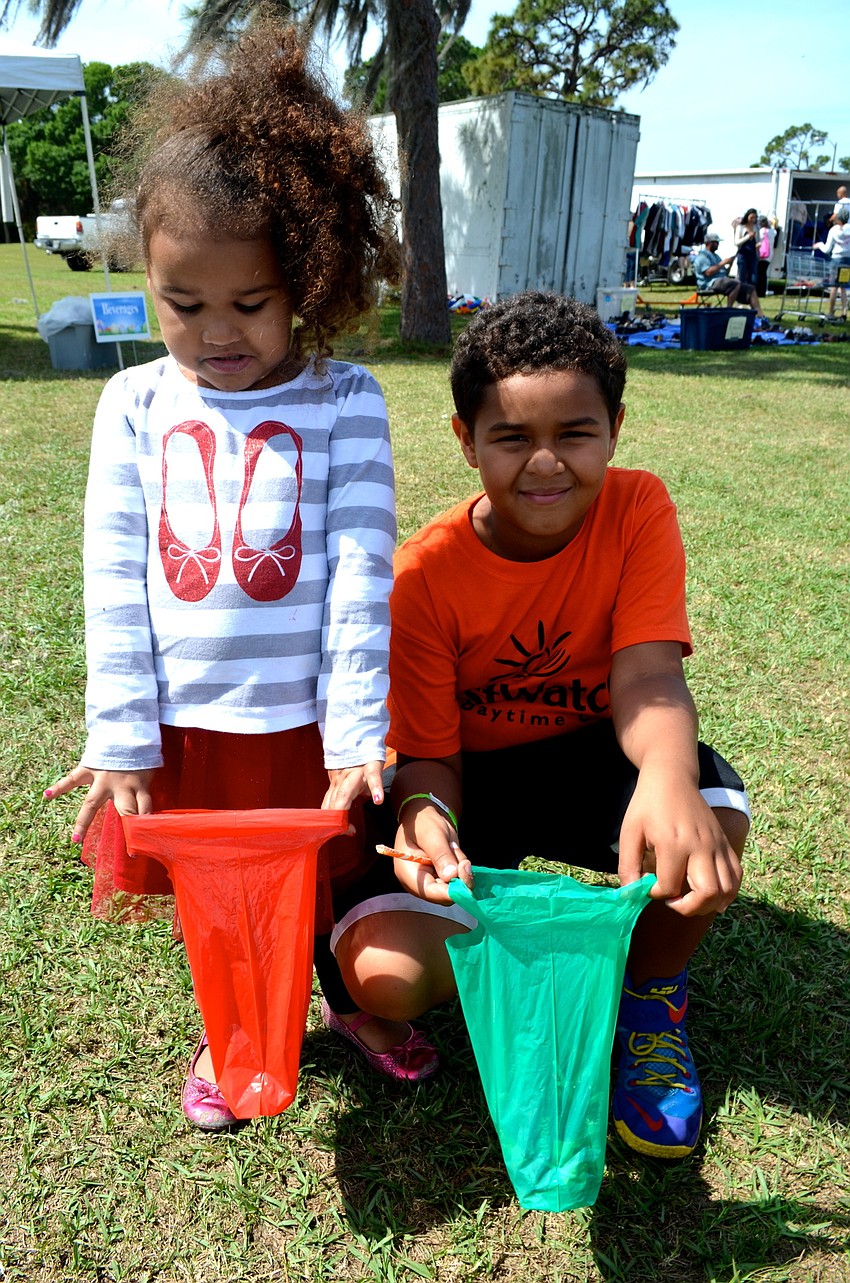 Olivia and Ethan Chivington show off their bags full of eggs.