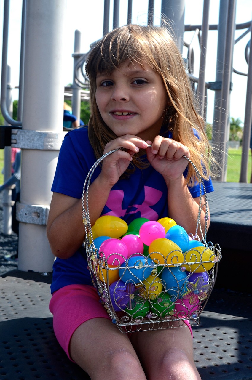 Seven-year-old Brooke Decillis holds her candy tight while playing on the playground.