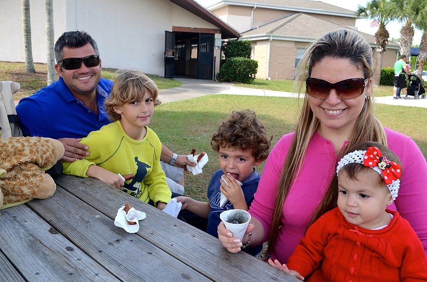 The Marqes family — Ricardo, Edward, Jordan, Luciana and Krystal — enjoy food and cold treats after a morning of hunting Easter eggs.