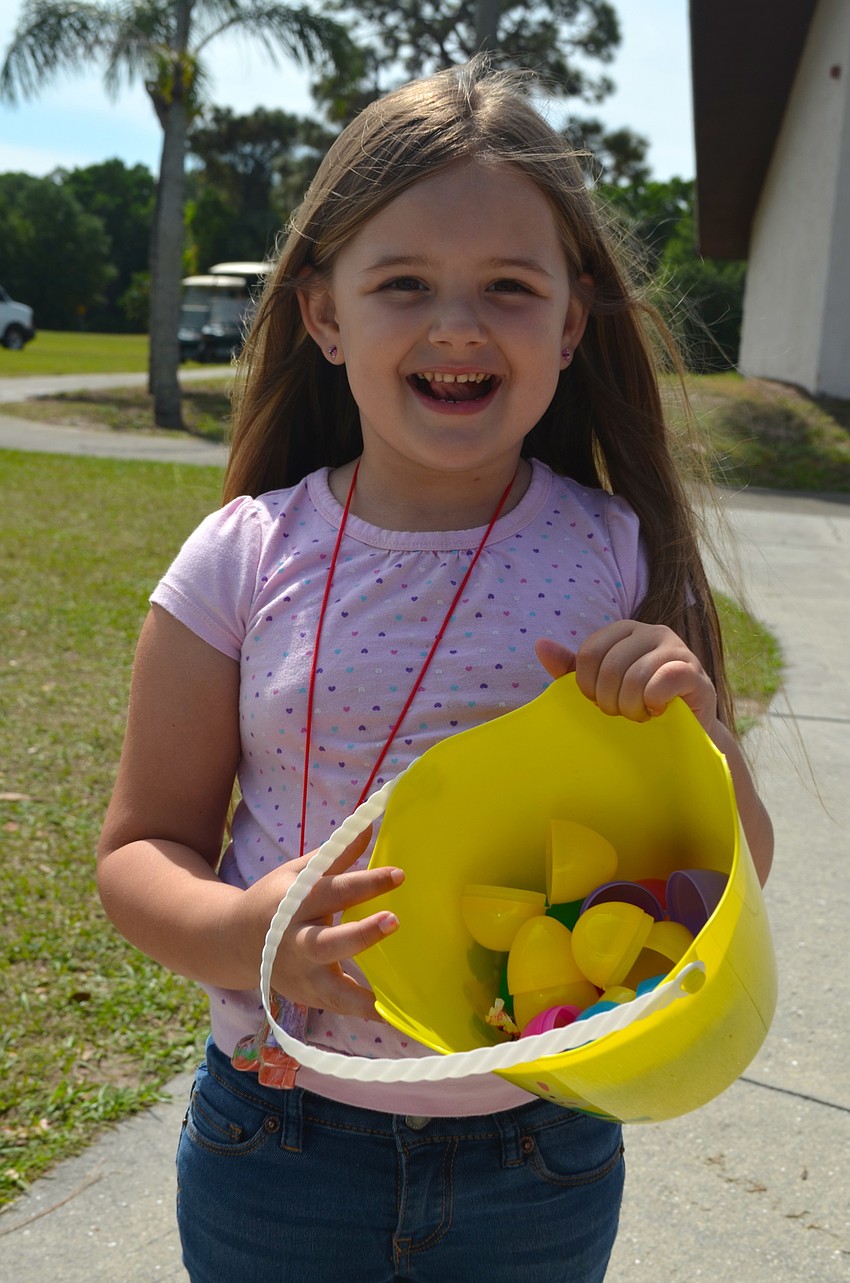 Five-year-old Rylin Scheller shows off her basket of eggs.