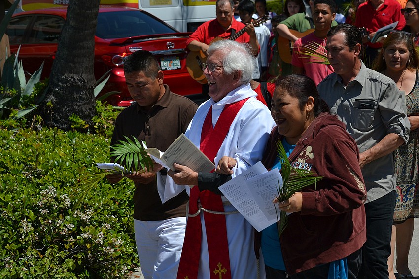 Members of the congregation sing songs during the palm procession.