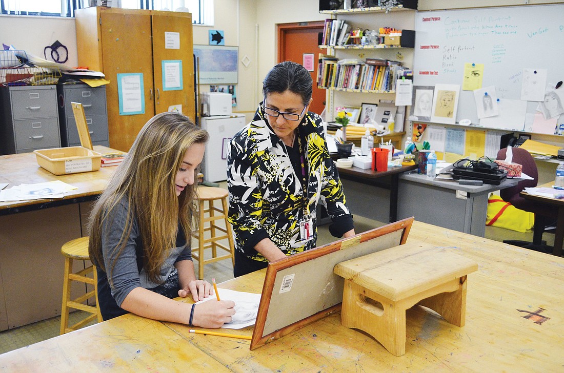 Mackenzie Reiss, an eighth-grader at Venice Middle School, sits down with her art teacher, Lisa Jodwalis, to discuss her next piece, a self portrait. Reissâ€™ work won best in show for students in this yearâ€™s Embracing Our Differences public art gallery.