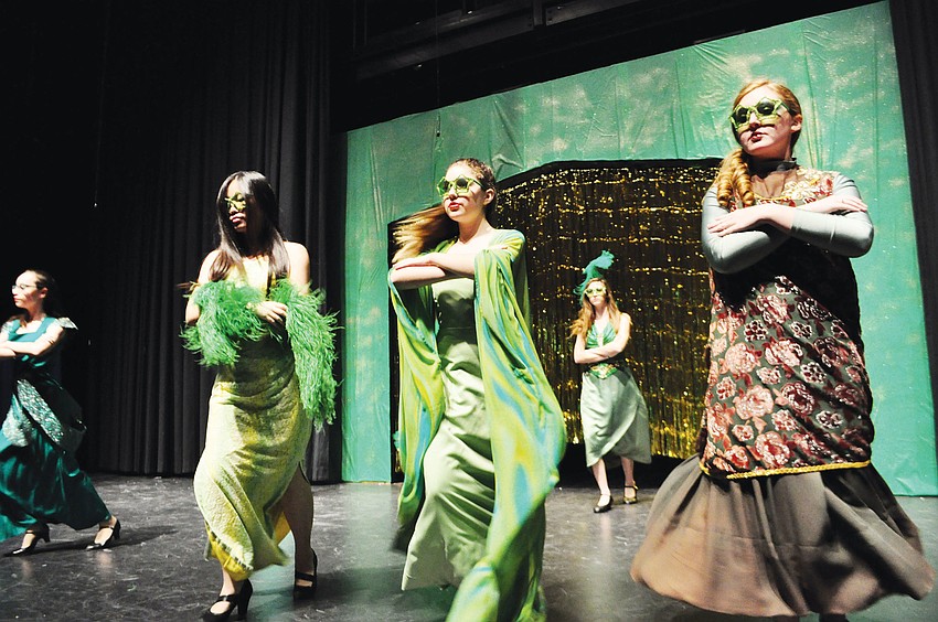 Emily Lui, Samiii Stine and Meg Phillips dance as Emerald City citizens.