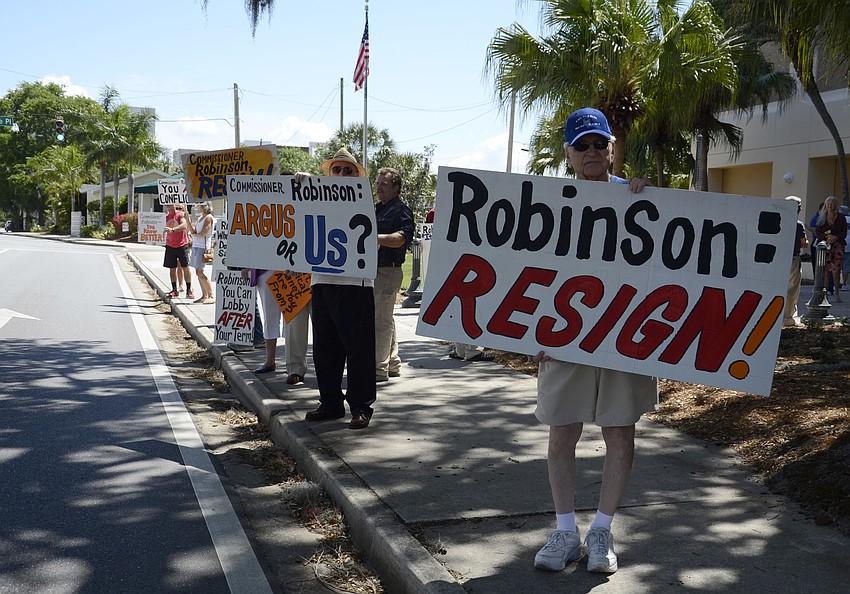Frank Cerullo, a downtown Sarasota resident and member of Control Growth Now, waves a sign on Ringling Boulevard.