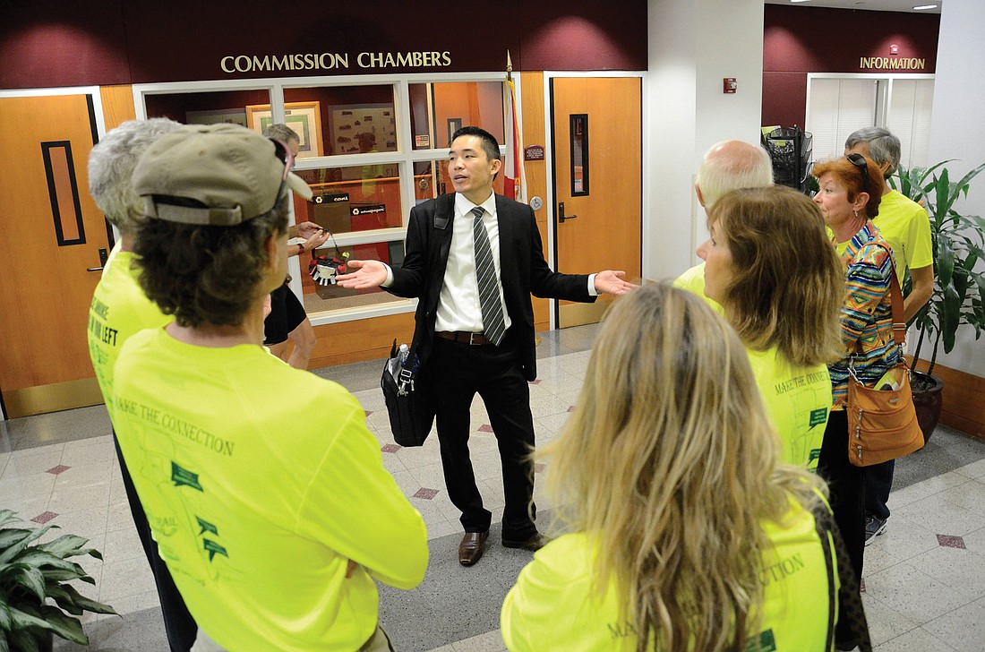 Patrick Lui, bicycle and pedestrian coordinator with Sarasota County, talks with Legacy Trail supporters Wednesday.