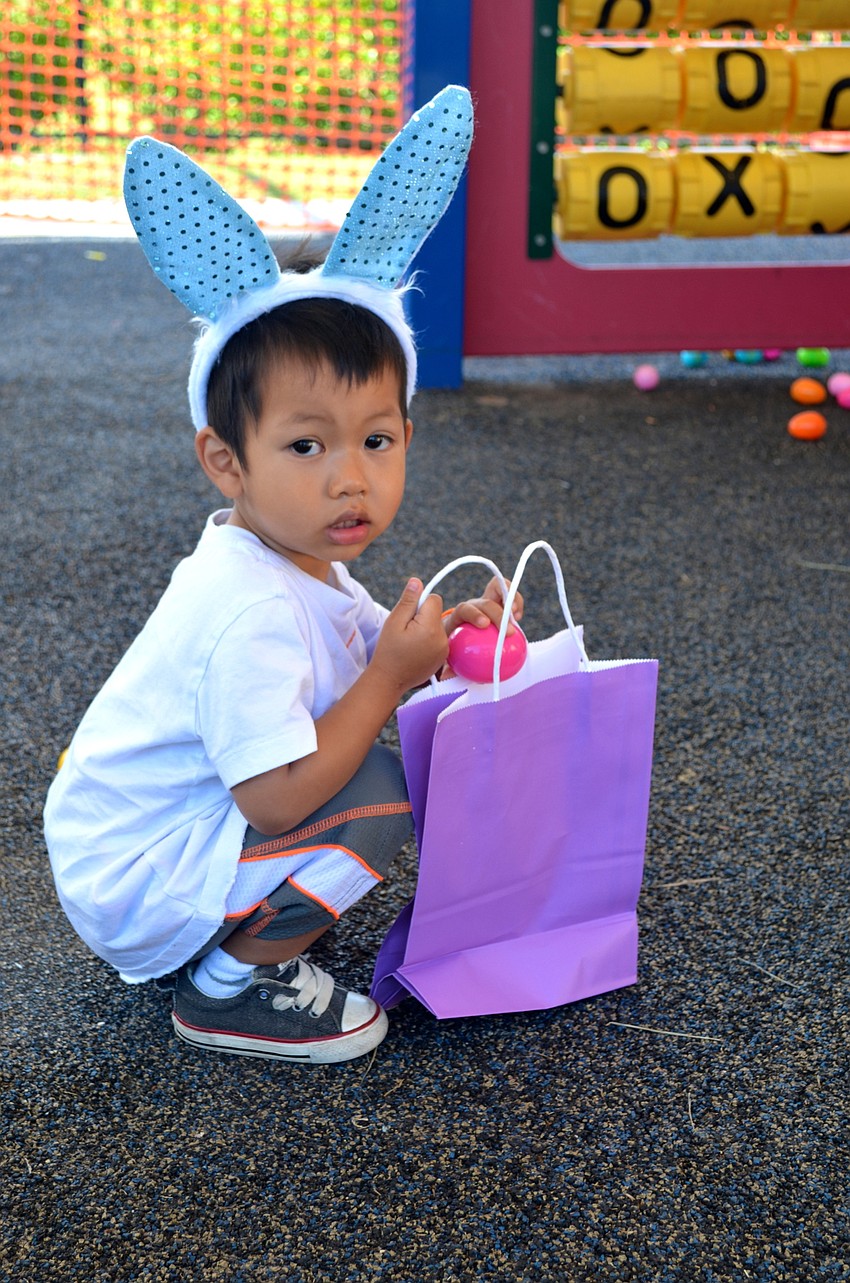 Micah Thepmanivong takes his time collecting eggs.