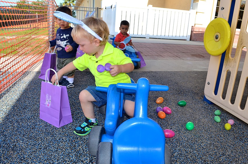 Cole Hay finds the Easter egg jackpot in the back corner of the playground.