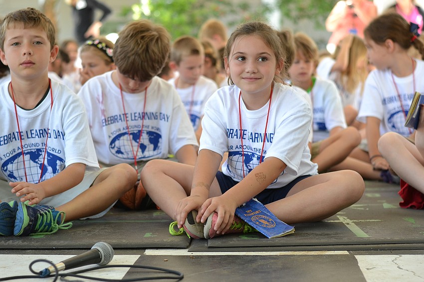 Gianna Ferreira does a butterfly pose during children’s yoga.