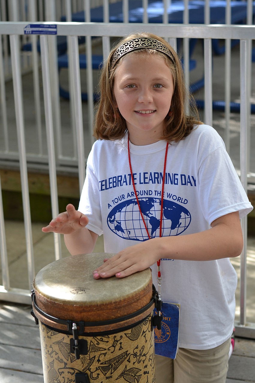 Kara Welch plays drums in the Africa section.