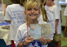 Madison Thomas shows off her passport stickers.