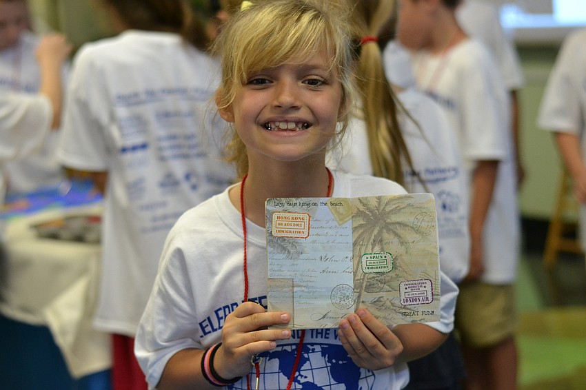 Madison Thomas shows off her passport stickers.