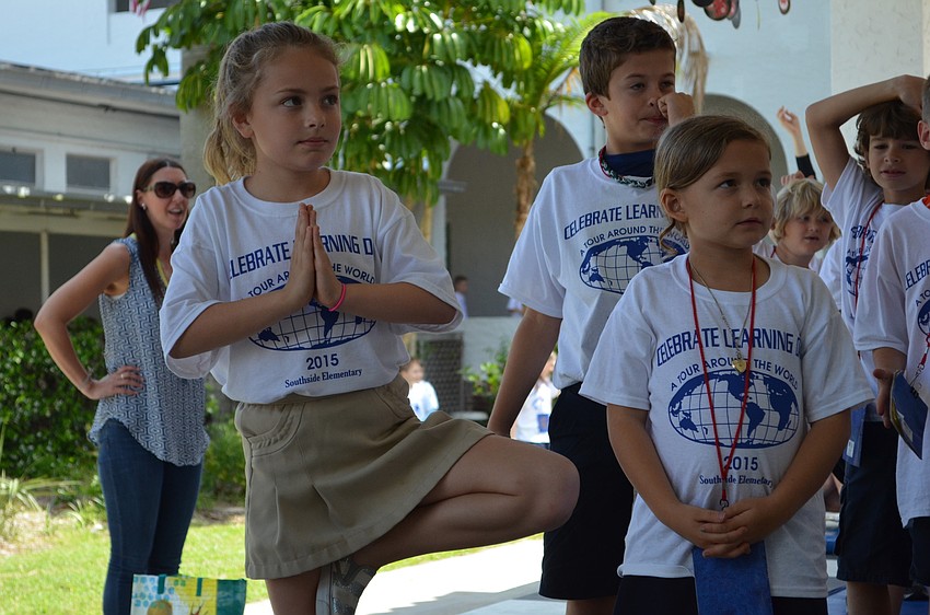 Ava Sims focuses during children’s yoga for the Asia portion of the day.
