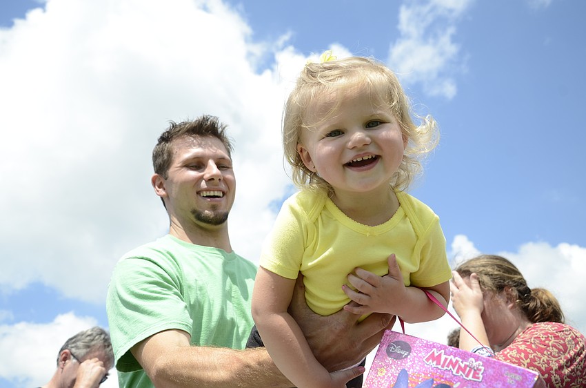 Gaetano Castiglione, and Brighton, 2, wait for the egg hunt. Brighton said she wanted to get two eggs.