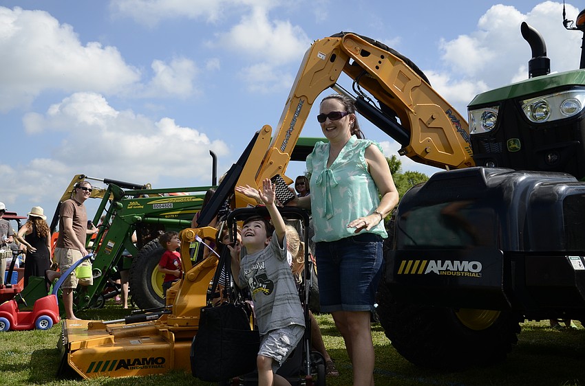 Dylan Krumm, 5, and his mom, Stevie, watch the camera drone flying over the event.