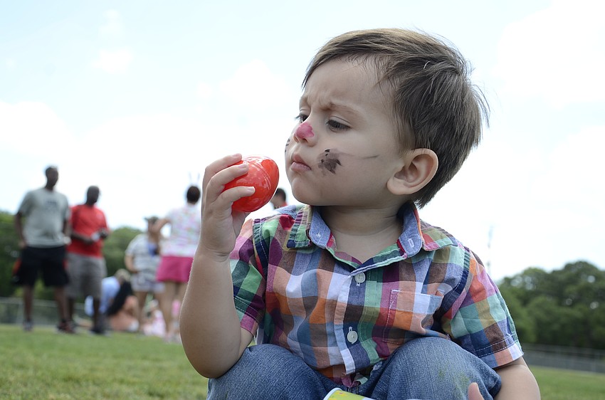 Marcelo Perez, 16 months old, checks out one of his eggs.