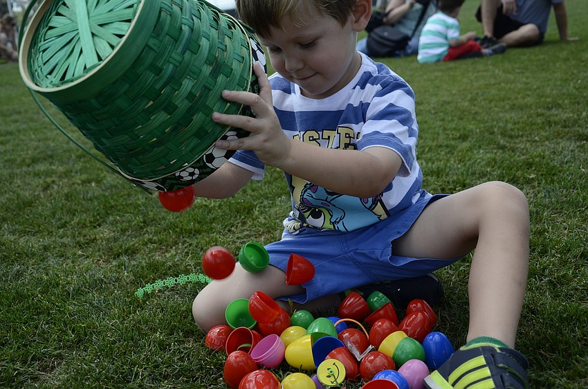 Matthew Allen, 3, unloads his eggs to check out what he found.