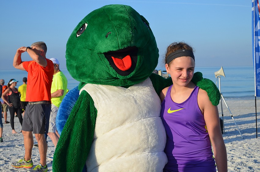 Shelly the turtle poses with Ella Kovach.