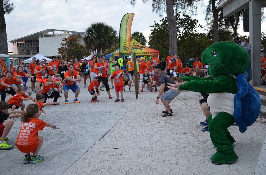 Shelly the turtle leads runners in a warm up before the race.