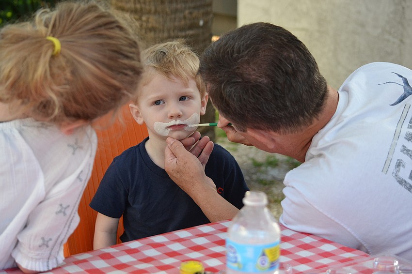 Graham Charland has his face painted like a bunny.