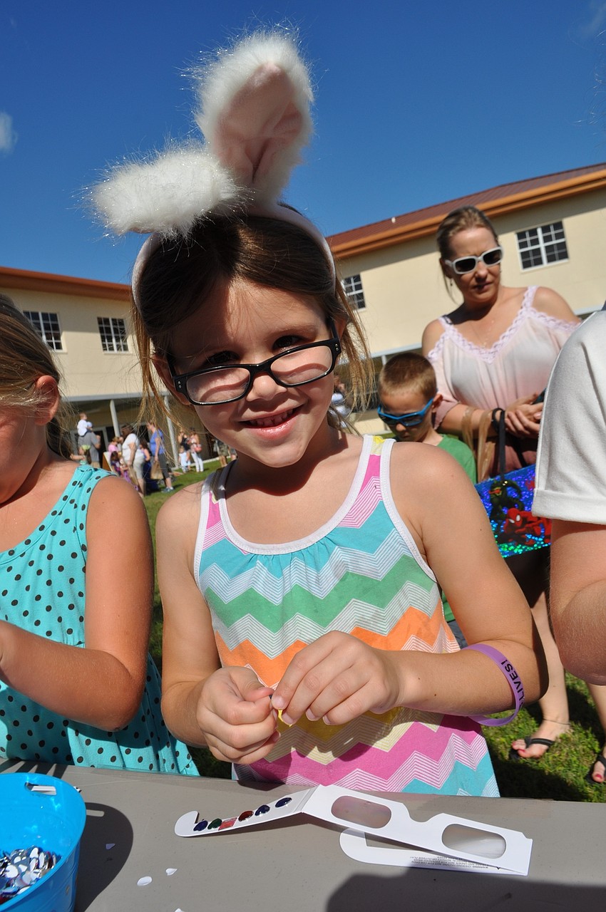 Lola Seelbach, 5, decorates a pair of glasses.