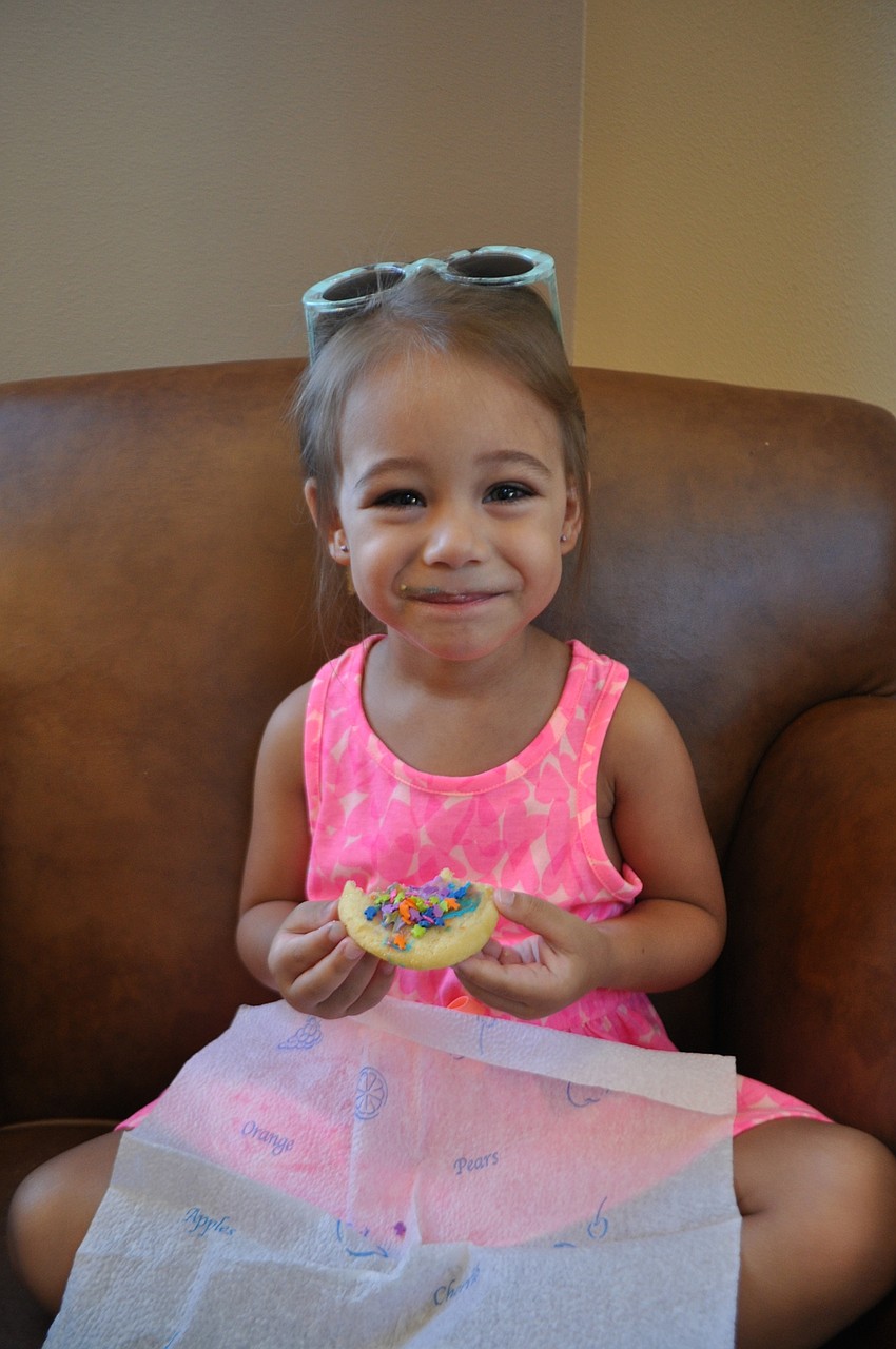 Lena Bartley finds a comfortable spot to eat the sugar cookie she decorated.