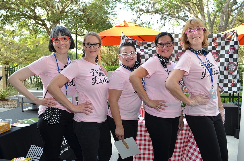 The ladies of Stearns Bank dressed as the Pink Ladies from “Grease.”