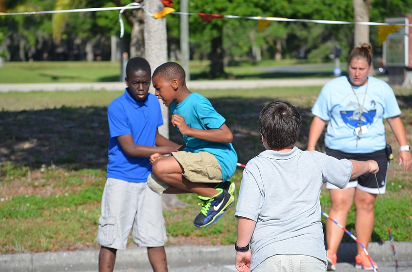Fifth-grader Jalanee Jones jumps as high as he can during a demonstration.