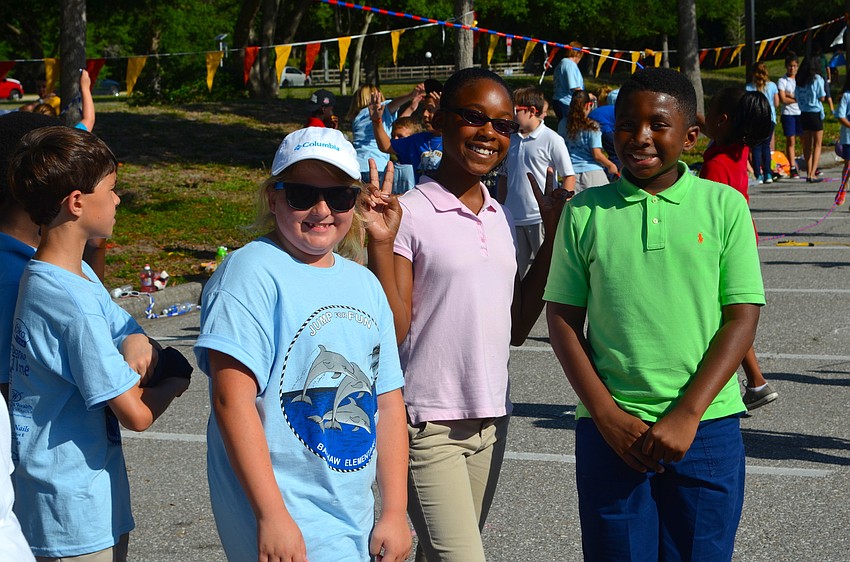 Tory Ziemer, Liani Smart and Kejon Robinson chat with friends while they wait to jump rope.