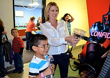 Justin Beaudoin challenges his mother, Michelle, to an arcade game.