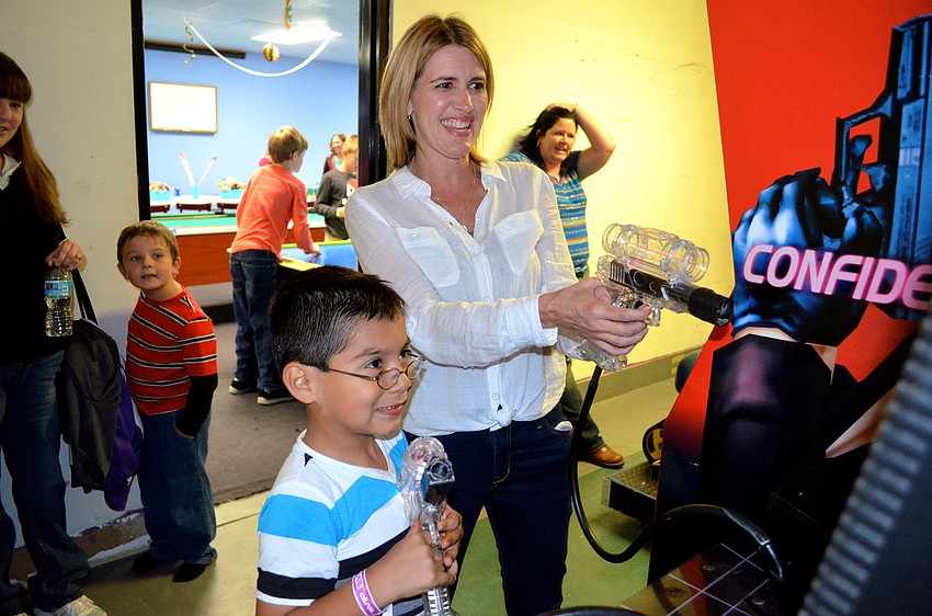 Justin Beaudoin challenges his mother, Michelle, to an arcade game.