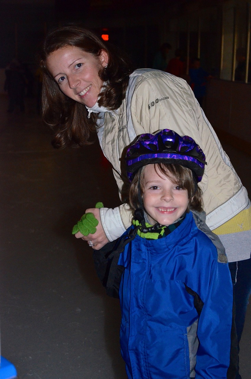 Bryce Albritton and his mother, Conny, take their first steps on the ice.