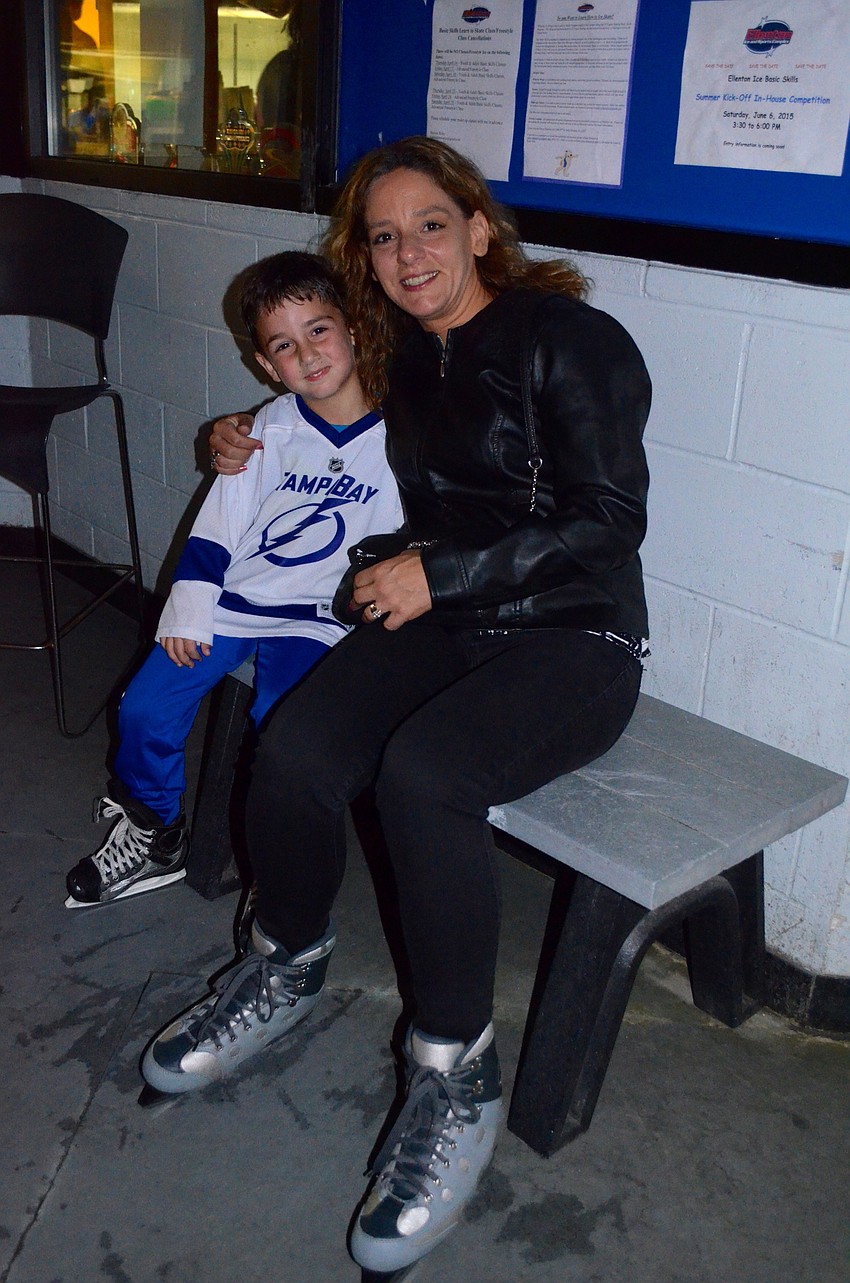 Luke Cotton and his mother, Monica, get ready to hit the ice after lacing up their skates.