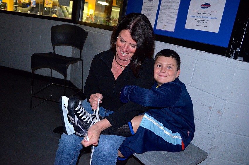 Ginger Mentzer helps her son, Jack, get ready for his ice skating debut.
