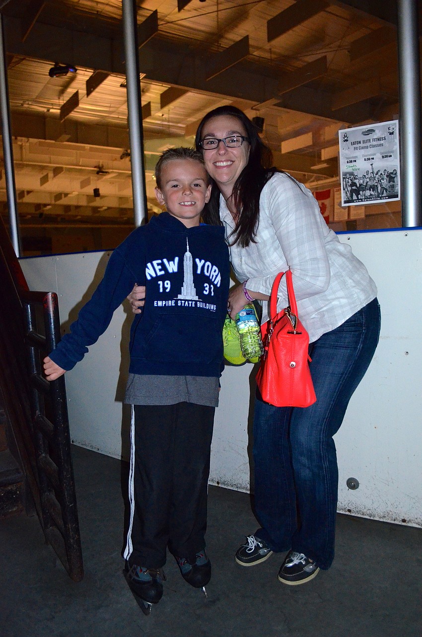 Lucas Salvant visits with his mother, Amy, after lapping the ice rink.