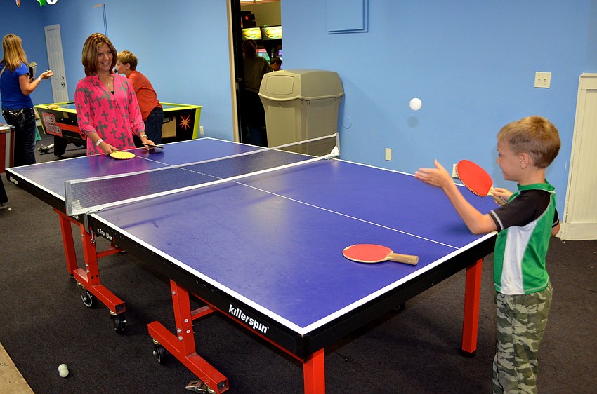 Molly Swindell challenges her son, Zach, to a game of ping-pong.