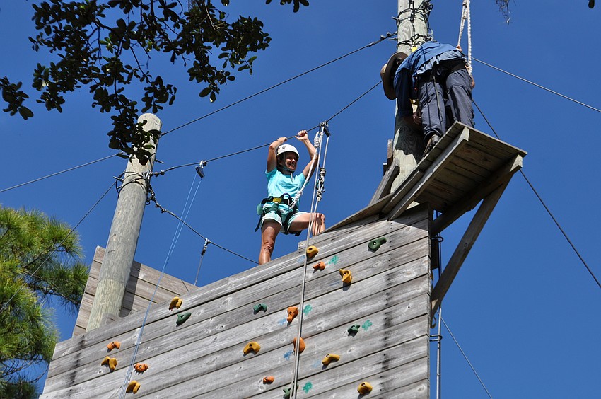 Gloria Ellsworth easily makes it to the top of the rock wall.